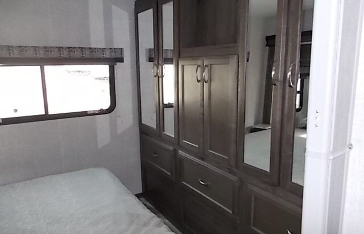 Lots of storage in the bedroom with Queen stationery bed