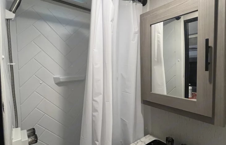 Full shower, Medicine cabinet with 1st aid kit.