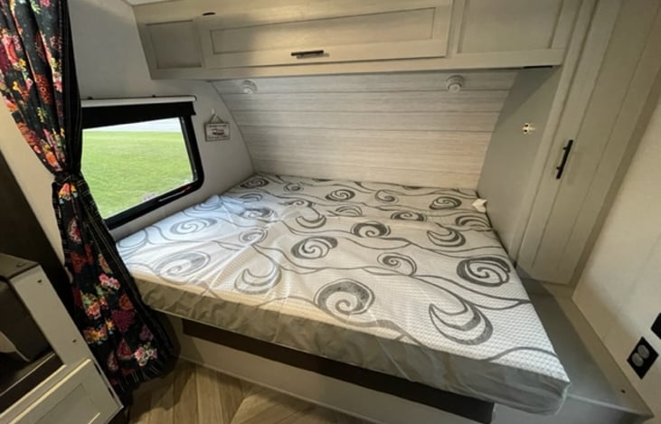 Master bed without linens.  Emergency exit window as well that can be used for ventilation.