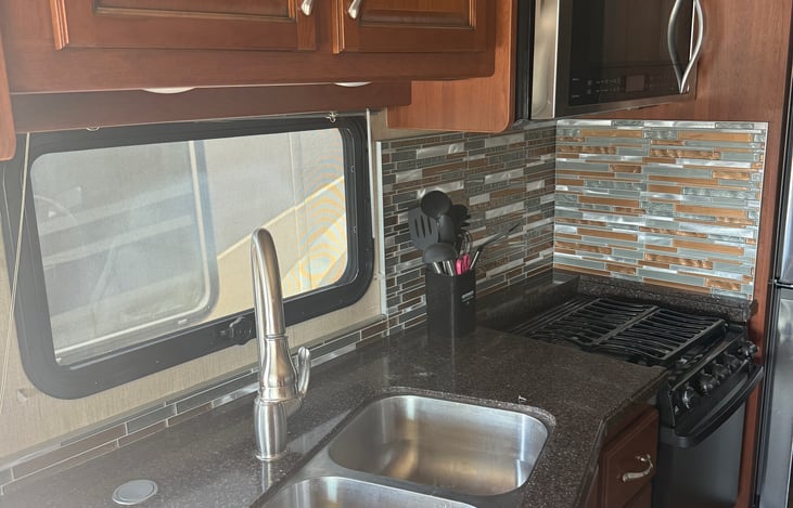 Full kitchen with stocked items allows for meal prep both on the go and at camp.