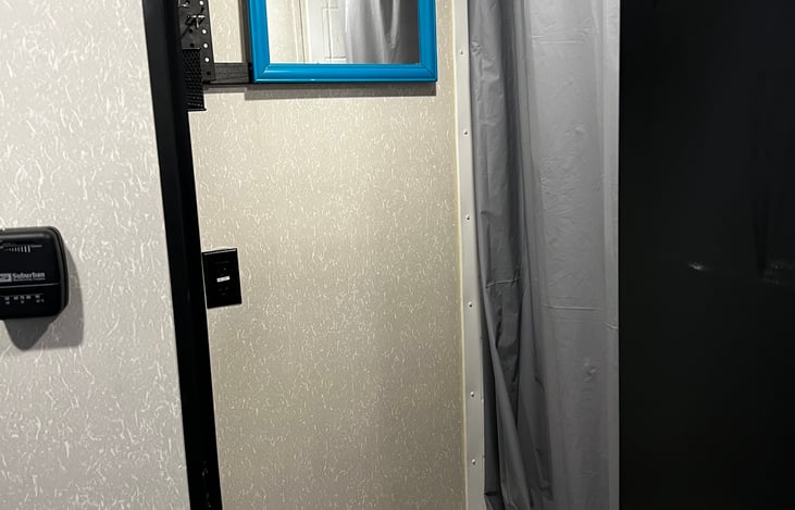 Bathroom side wall with mirror and storage