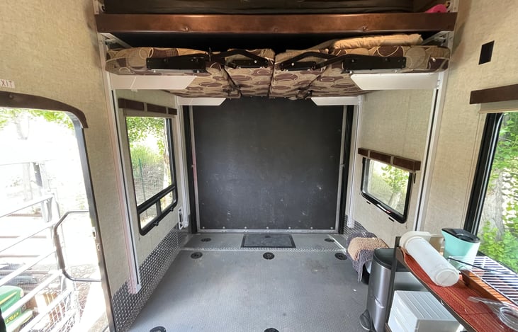 Garage looking front to back. Two electric slide down
beds. Lower bed converts to 6 place table and couch
seating.