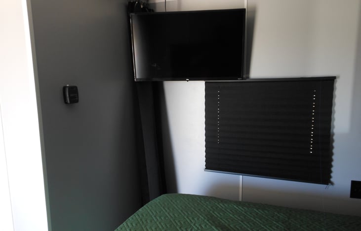 Bedroom has new smart TV , blackout curtains and plenty of storage.