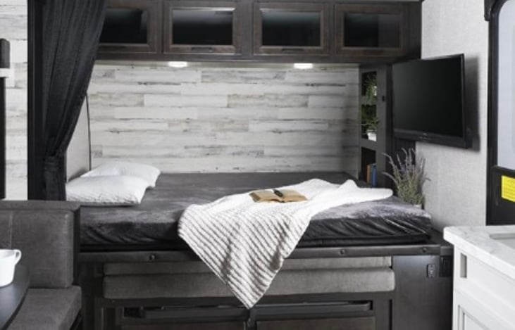 Murphy bed opens to queen size bed. Privacy curtain covers entire bed area. TV on a swivel.