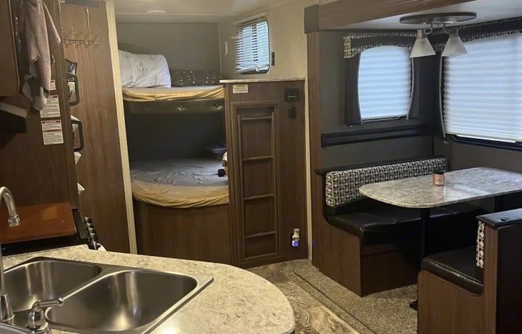 Full size bunks. Kitchenette can fold into a bed.