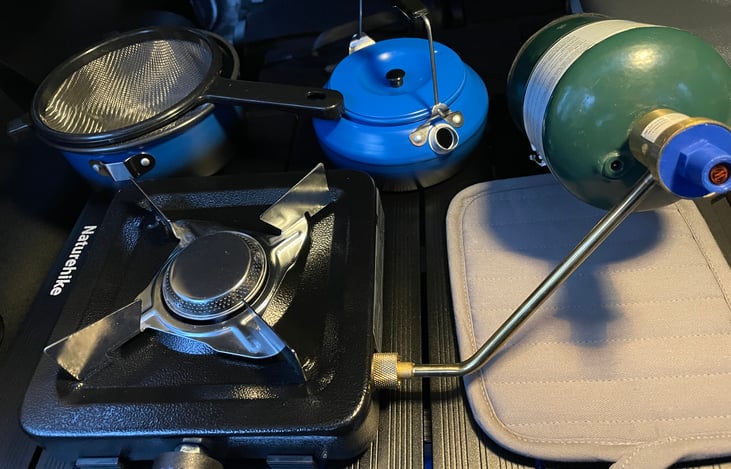 The lightweight single burner propane stove shown with correct setup. The regulator arm must be secured snug to the stove so the tank supports the stove. Sort of like a kickstand.