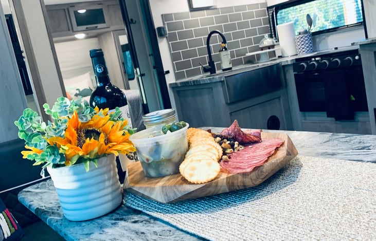 Full size Sink, Oven and 3 burner Gas stove, Coffee maker, and Ice maker (upon request). Plus the Full Size hidden pantry behind the TV!