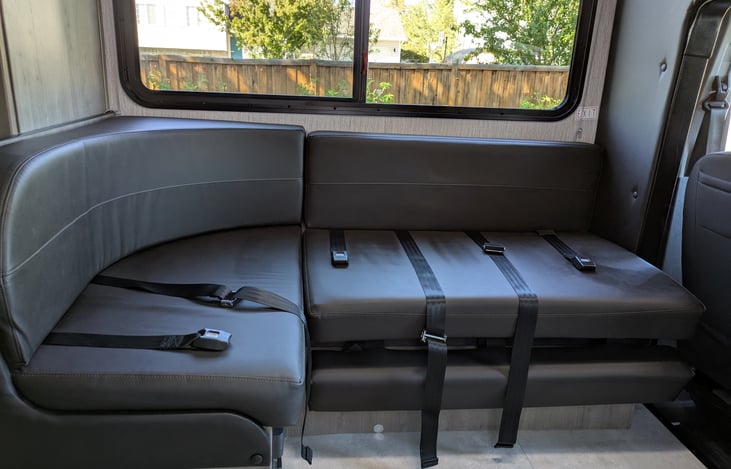 One seat belt facing the windshield with a car seat latch if needed. Two seat belts along the window. One seat belt for the seat behind the passenger seat.