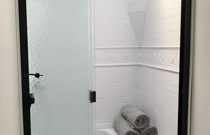 Shower door slides open and closed.