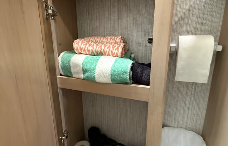 Towels provided for your stay, including bath towels, hand towels, and washcloths, plus RV-safe toilet paper, a hair dryer, and backup toiletries.