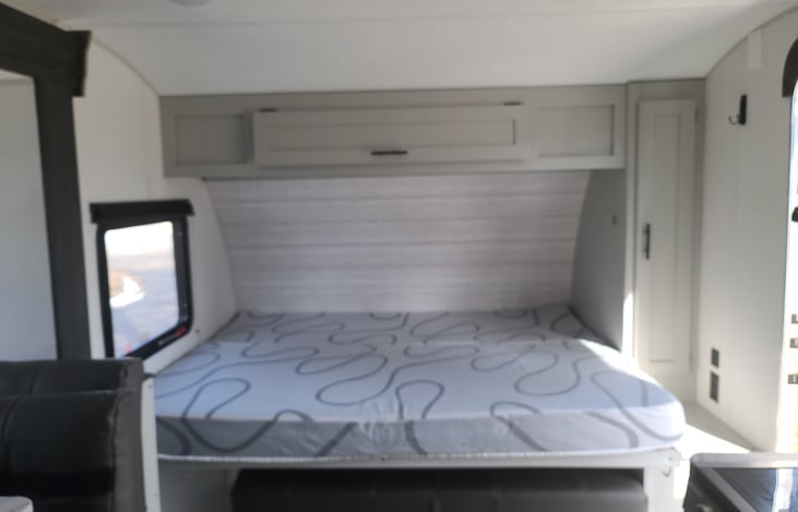 Queen Murphy bed which folds up to show the couch underneath.