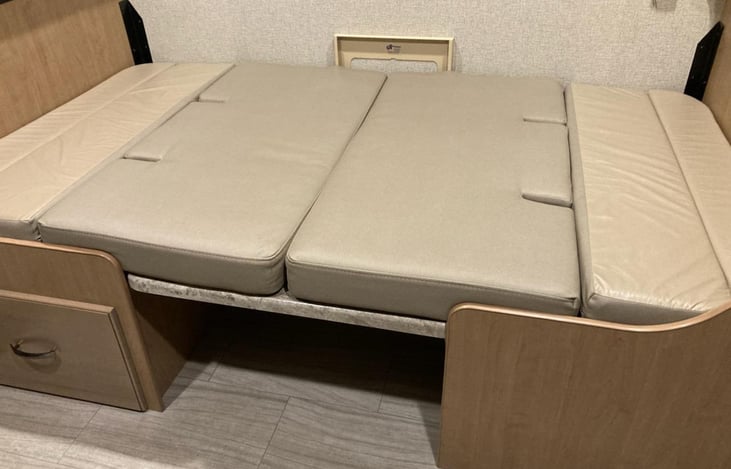 Dining table drops down and turns into a 42" wide x 72" long bed.