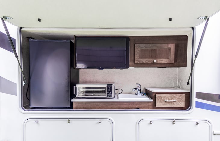 Outside Kitchen with TV, Fridge, and Sink