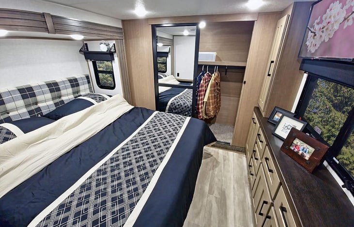 Master with large closet, dresser and smart TV.