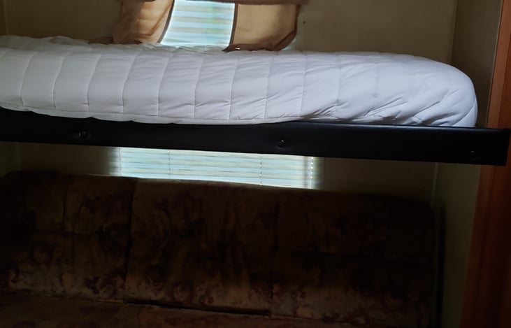 Left side bunk with bottom bunk folded into a couch