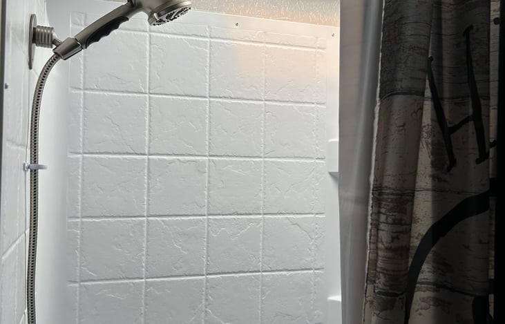 Upgrade shower head. The skylight allows extra head room for taller people