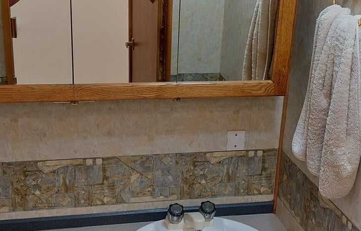 Bathroom and toilet, good cabinet space.