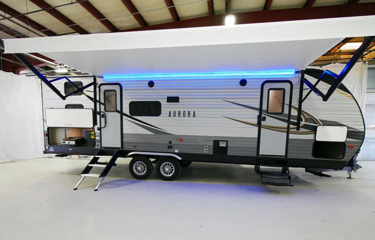 Side view, 18ft. awning, LED light strip, private entrance/exit for master bedroom, outdoor kitchen (griddle,toaster/airfryer,beer-fridge,cabinet) . large protected storage compartment.