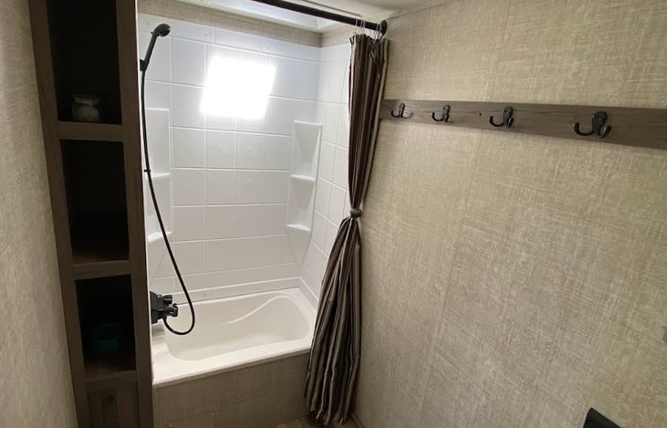 Nice size restroom with sanitary foot flush toilet.