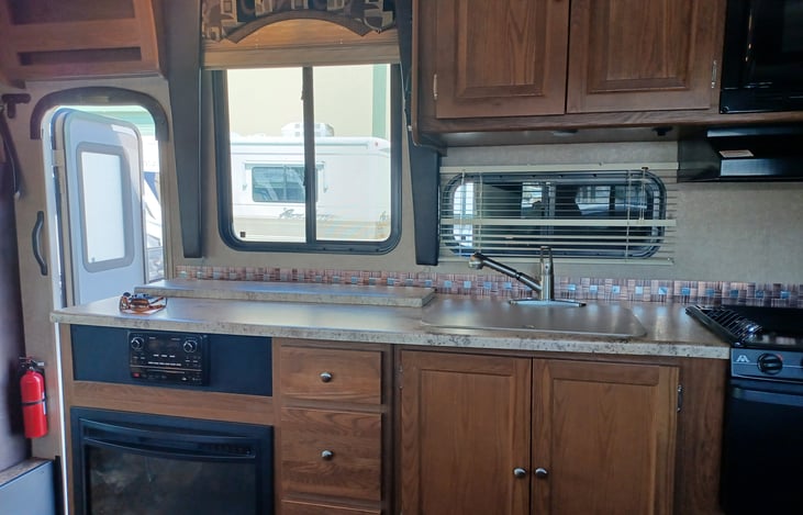 TV that retracts into counter with fireplace