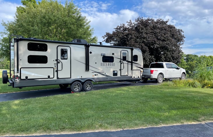2023 Rockwood Ultra Lite Bunkhouse with exterior kitchen, exterior shower, double awnings, exterior lighting and sound system, and ample storage.