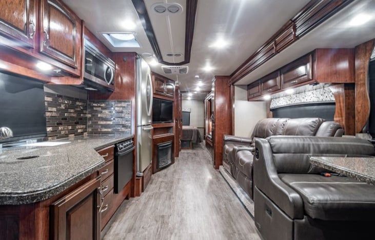 Dining table seats 4, driver/passenger seats also serve as eating area for a total of 6. Living room TV and electric fireplace.