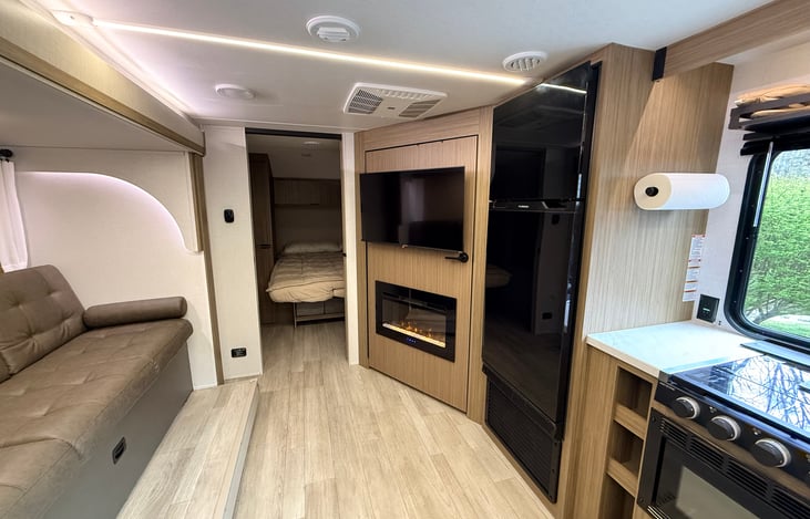 Electric fireplace and smart TV with hidden pantry, refrigerator/freezer