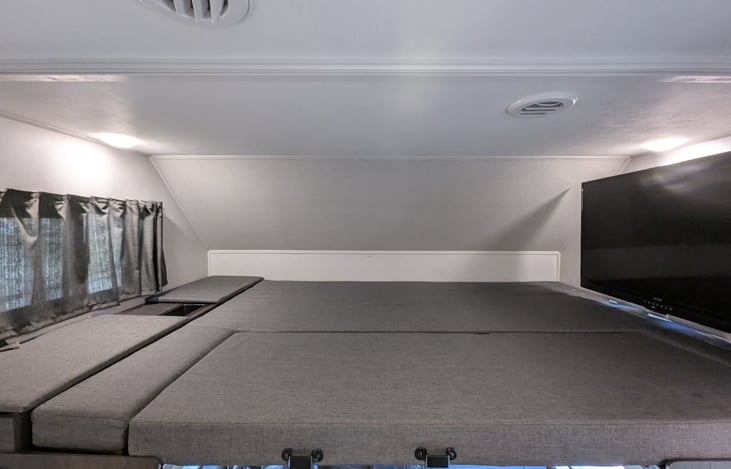 Comfy overhead Queen bed with swing-out TV.