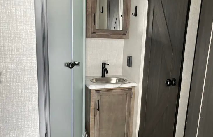 Restroom has enclosed shower, sink, toilet, and linen closet.  Linen closet is stocked with up to 8 towel sets.