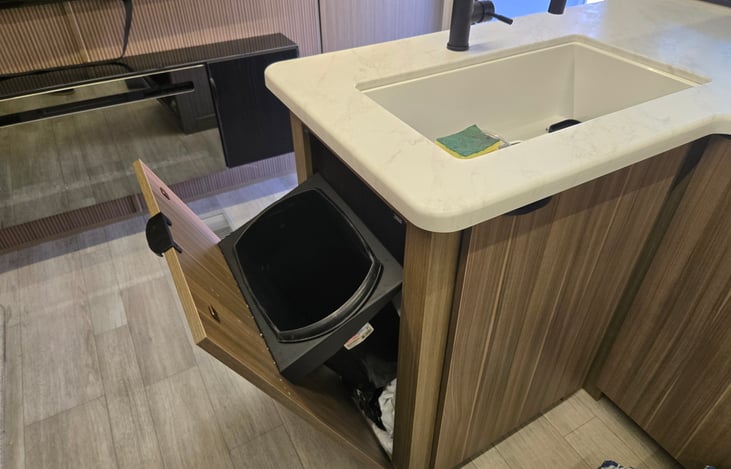 Hidden trash so its not in the way and full size kitchen sink