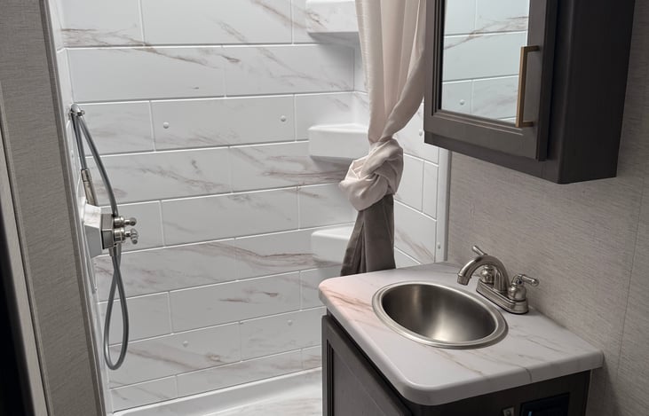 Bathroom with behind mirror storage and bath towels