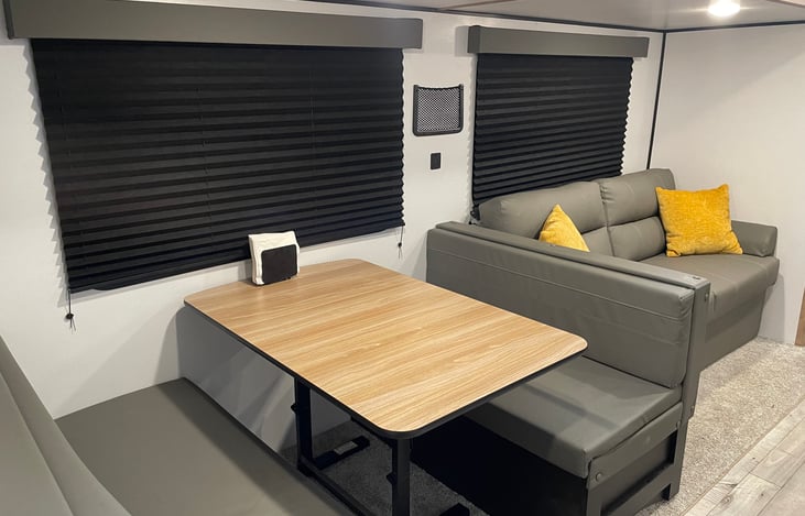 Dining area and couch that both convert to beds.