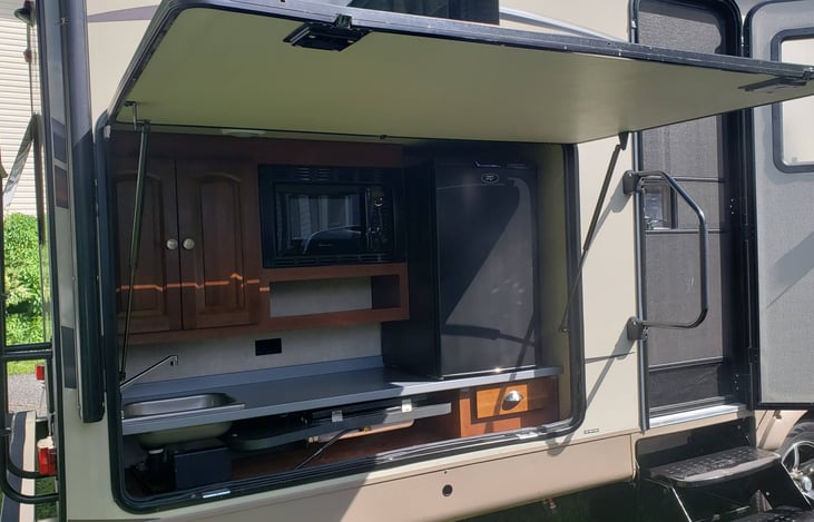 Outdoor Kitchen with Refrigerator, 2 burner stove, Sink with working plumbing, Microwave, Toaster Oven, Coffee Maker and storage