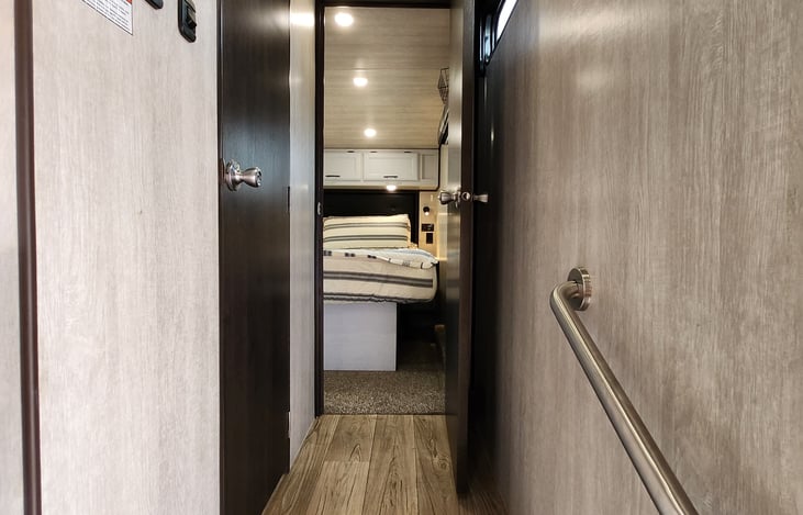 Stairs lead to the bathroom and private room. Generator controls are also located here.