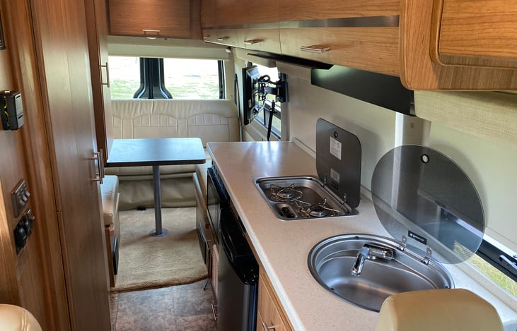 The glass covers over the sink and burners give extra counter space