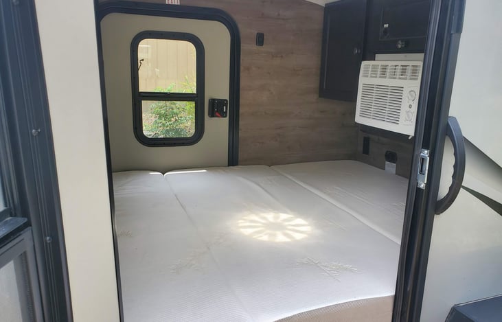 Upgraded 4" foam mattress, the trailer is equipped with AC and 2 entry doors.