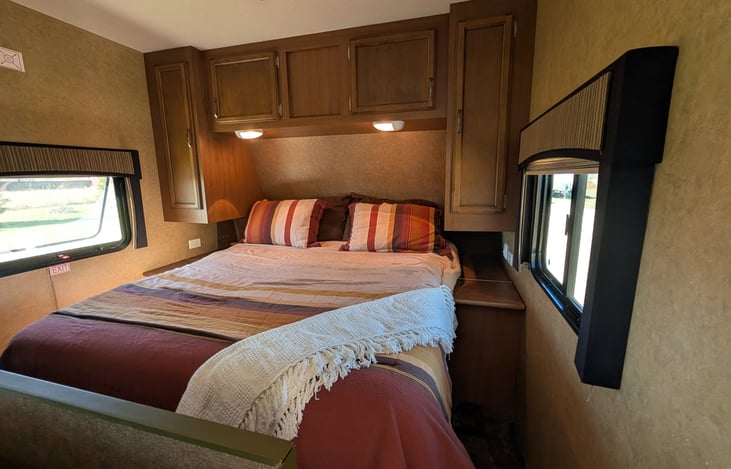 Main Queen Bed - curtain for privacy, outlets on both sides and outside light switch.