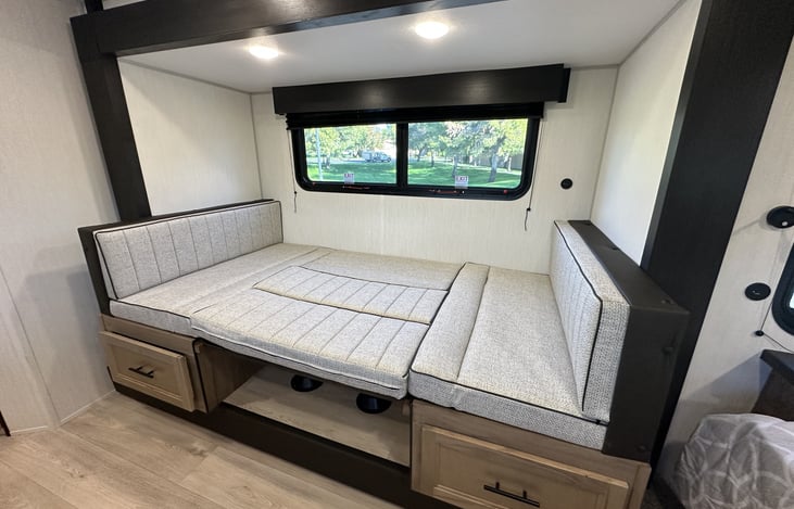 Dinette seating area by large window for meals and relaxing.