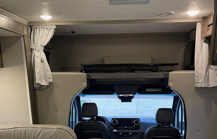 Bunk, with privacy curtain. Cargo/safety-net secures with straps & hooks on ceiling