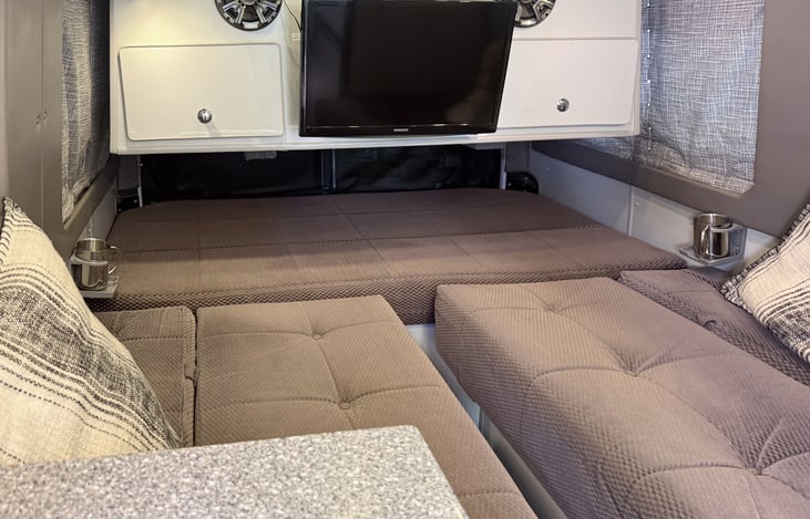 70x82 bed to sleep when seats folded down. foam toppers and sheets added to this set up.