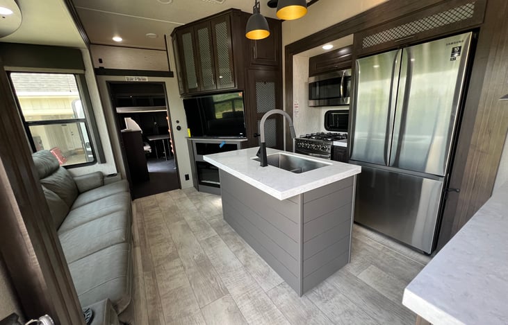 Super-nice kitchen and living room with full-size refrigerator