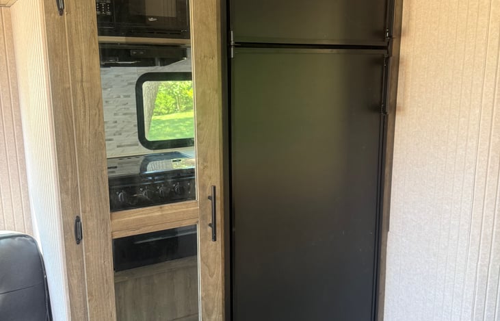 Refrigerator & separate freezer, plus pantry with sliding shelves.