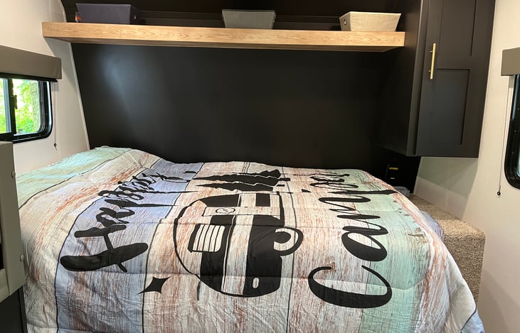 Queen bed, closet space, and top shelf storage.