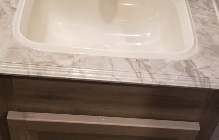 Sink vanity area with mirror not pictured