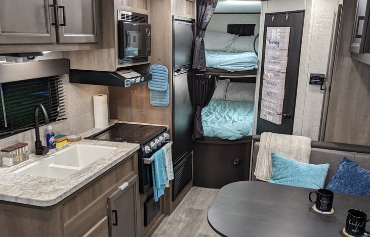 Double bed sized bunk beds each with their own privacy curtain, reading light, window, and power. (pictured with Extra linen package)