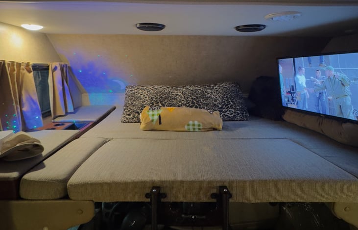 Cab-Over Bunk that converts into sleeping area + TV