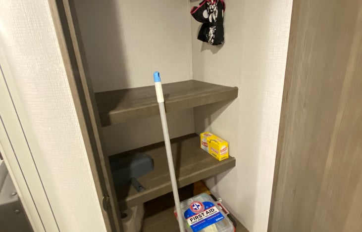 Pantry with broom, umbrella, first aid kit