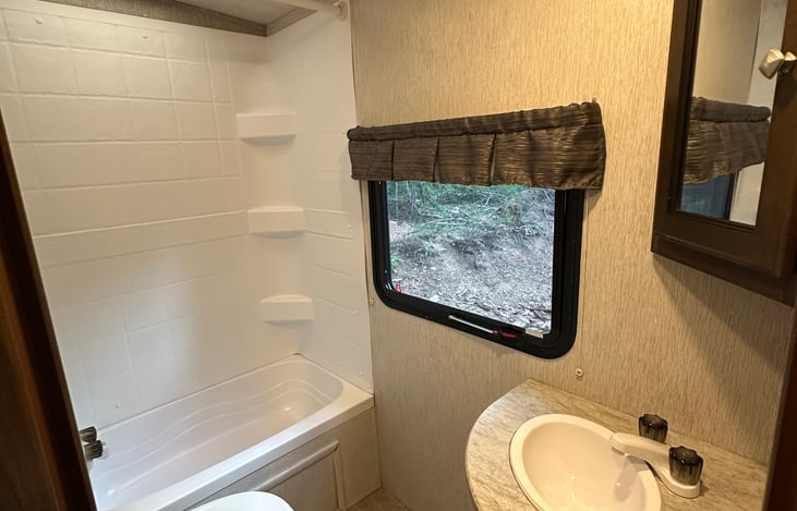 Bathroom with shower, tub, sink, and toilet