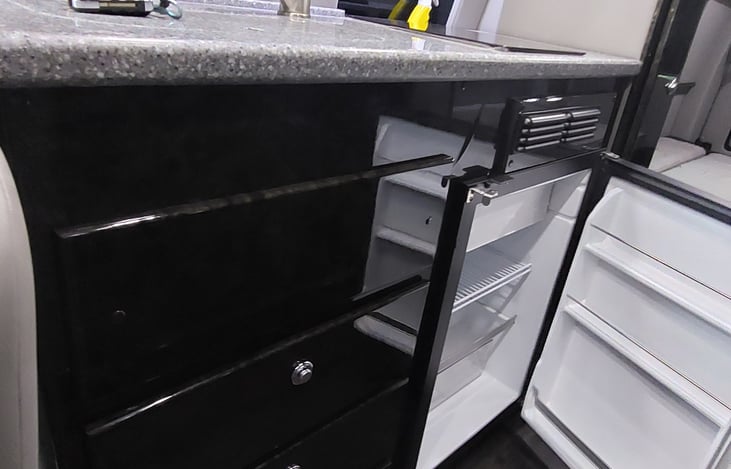 The refrigerator has enough room to store the carry out, keep the groceries fresh, and the drinks cool! There is even a little freezer for microwave sized items.