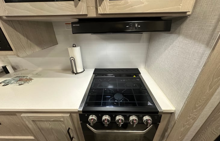 Kitchen provides a microwave, small size stove and gas oven.